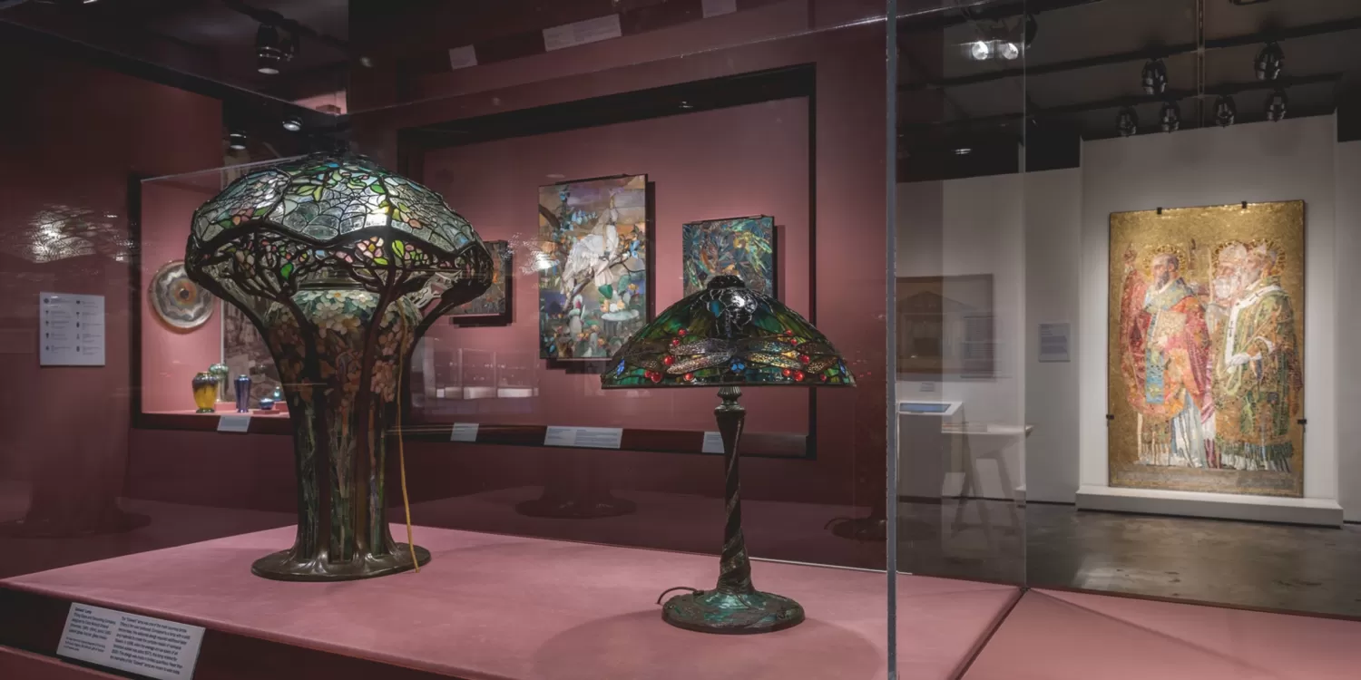 A group of Tiffany lamps on display in The Neustadt Gallery at the Queens Museum