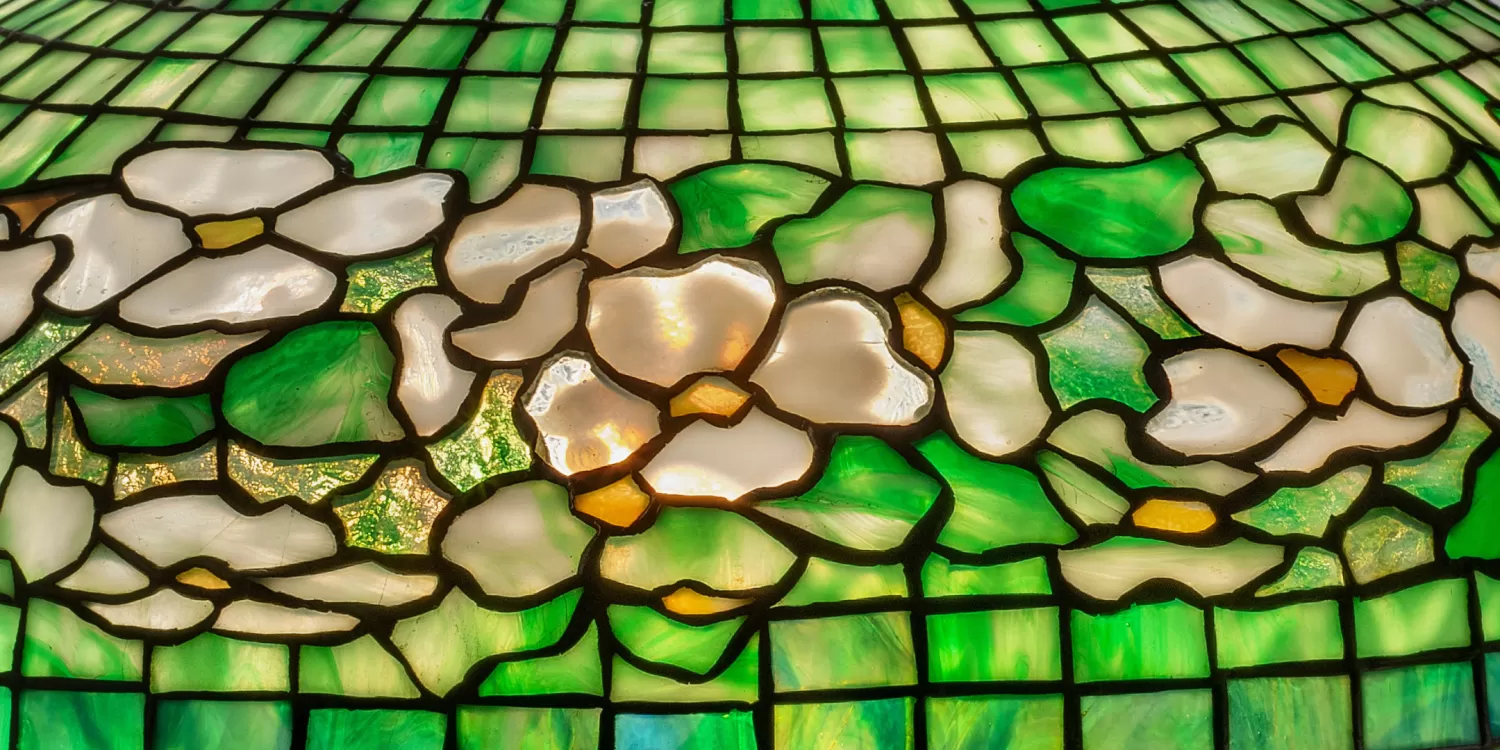 stained glass lamp detail of white flowers with green background