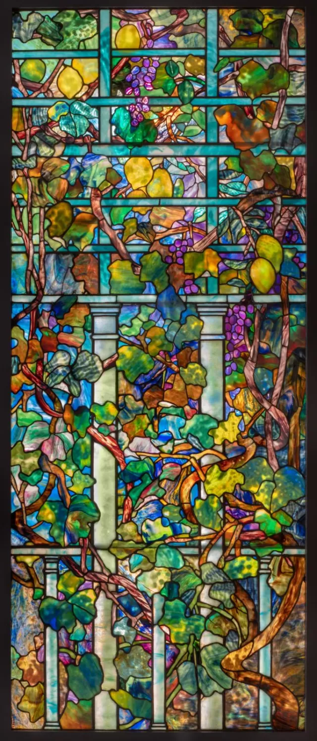 Vertical rectangular opalescent glass window featuring lemons, grapes, and trellis.