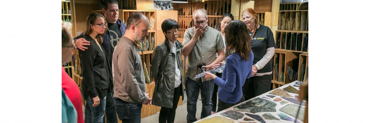 Curator explaining Tiffany glass to a tour group in the Tiffany glass archive