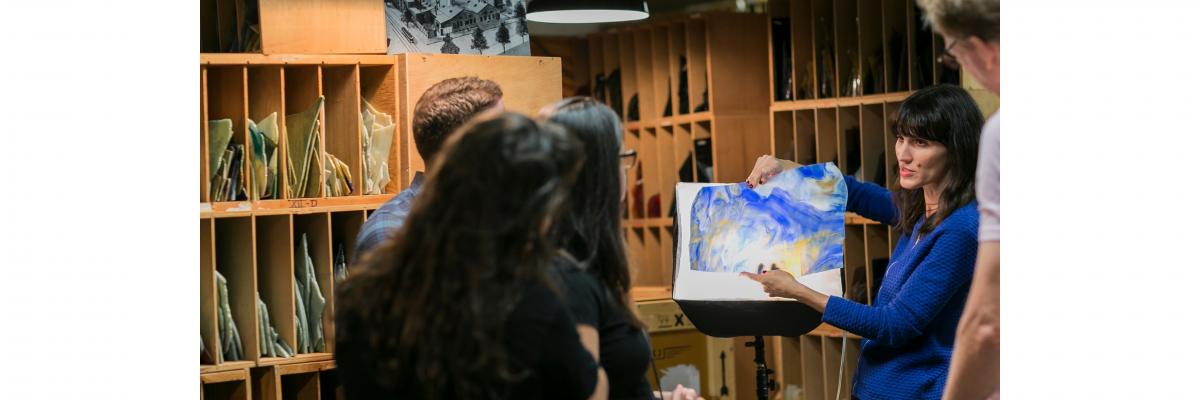 Curator explaining Tiffany glass to a tour group in the Tiffany glass archive