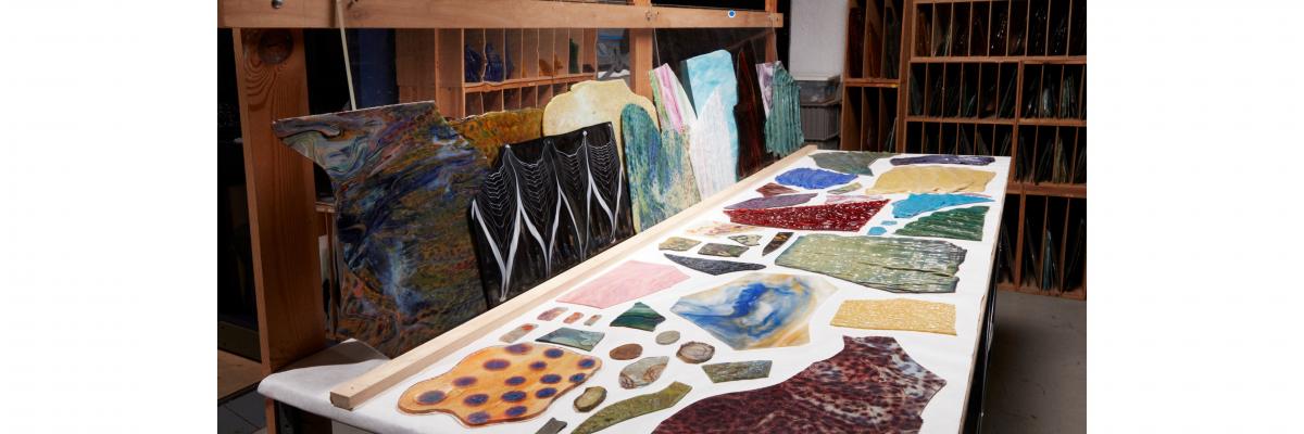 Glass on display on a worktable at the Tiffany Glass Archive